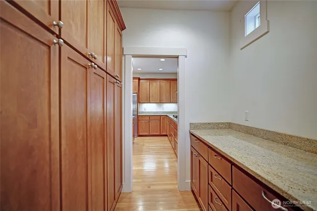 a hallway with sink and cabinets
