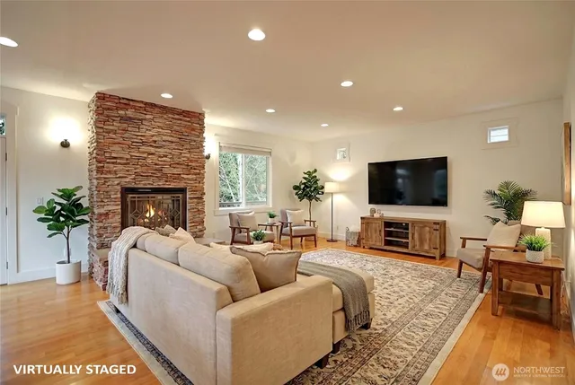 a living room with furniture a fireplace and a flat screen tv