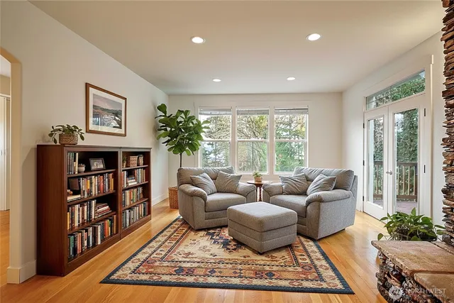 a living room with furniture and a book shelf