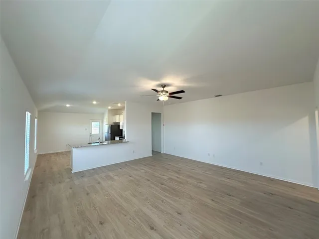 a view of a livingroom with a ceiling fan window and a ceiling fan