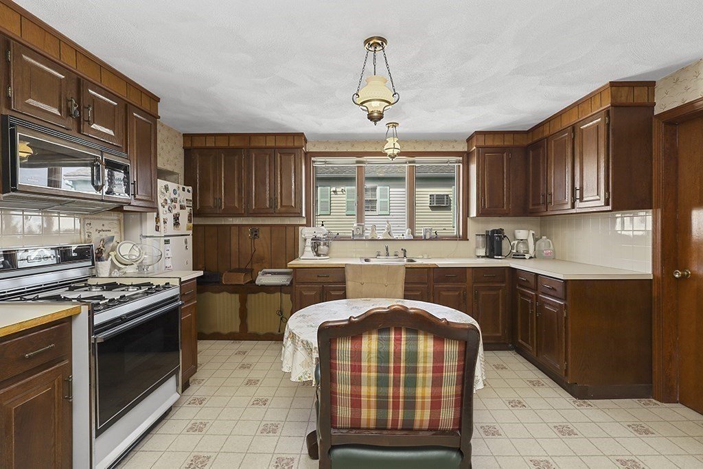 61 Everett Street Everett, MA 02149 - Photo 12 of 19 a kitchen with stainless steel appliances granite countertop a stove sink and cabinets