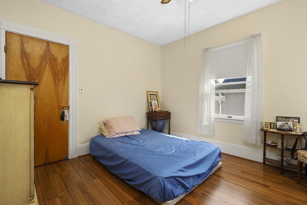 61 Everett Street Everett, MA 02149 - Photo 14 of 19 a bedroom with a bed and wooden floor