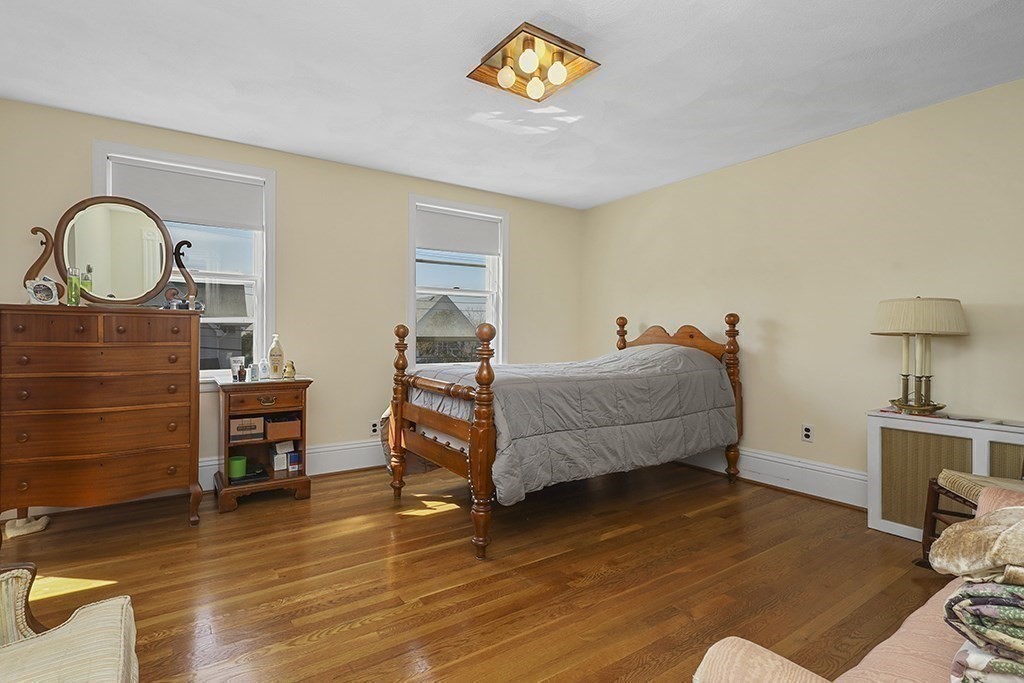 61 Everett Street Everett, MA 02149 - Photo 15 of 19 a bedroom with a bed and a dresser next to a window
