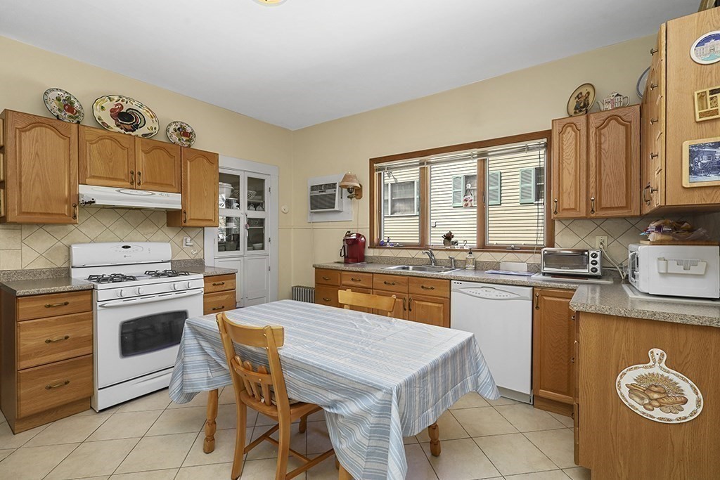 61 Everett Street Everett, MA 02149 - Photo 4 of 19 a kitchen with a stove a sink and a refrigerator