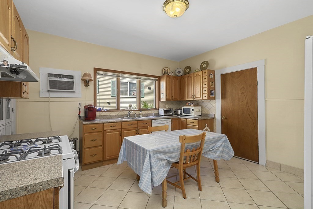 61 Everett Street Everett, MA 02149 - Photo 6 of 19 a large kitchen with a table and chairs in it