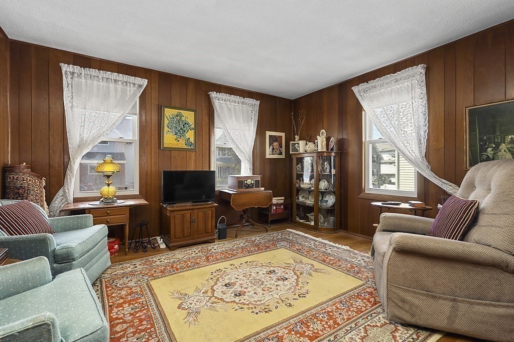 61 Everett Street Everett, MA 02149 - Photo 7 of 19 a living room with furniture and a flat screen tv
