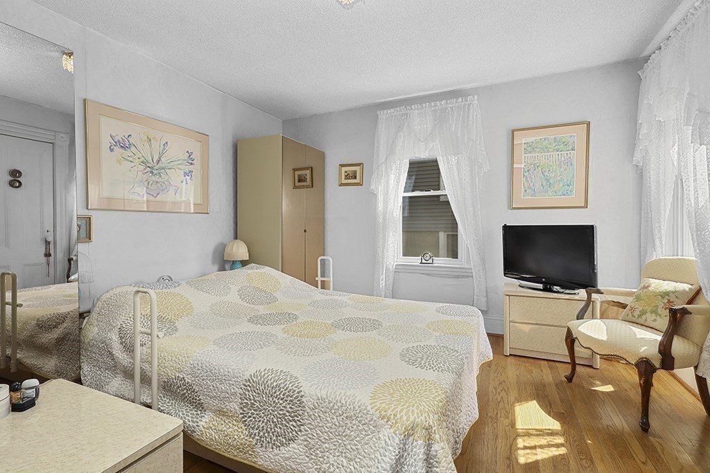 61 Everett Street Everett, MA 02149 - Photo 9 of 19 a bedroom with a bed and a flat screen tv