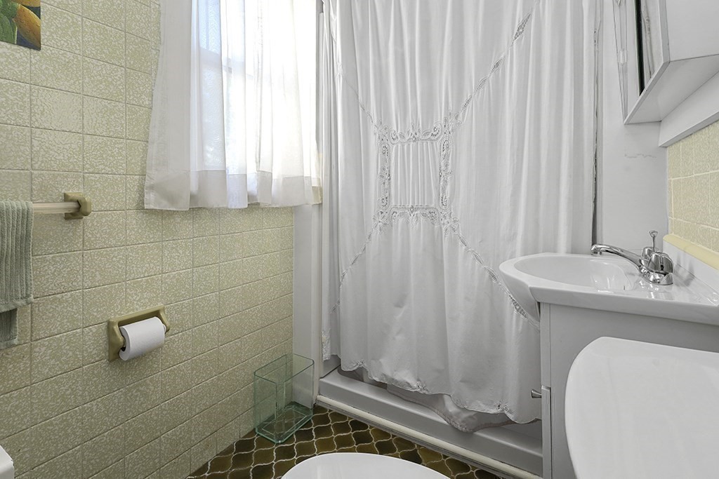 61 Everett Street Everett, MA 02149 - Photo 10 of 19 a bathroom with a sink a toilet and shower