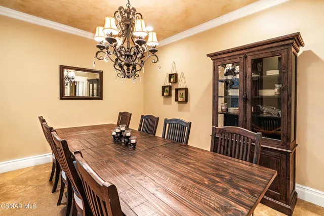 a view of a dining room with furniture and chandelier