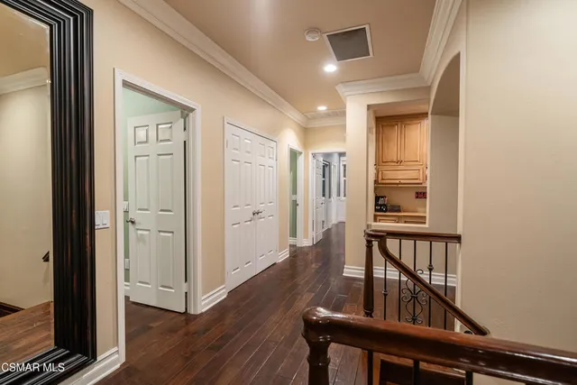 a view of a hallway with wooden floor and entryway