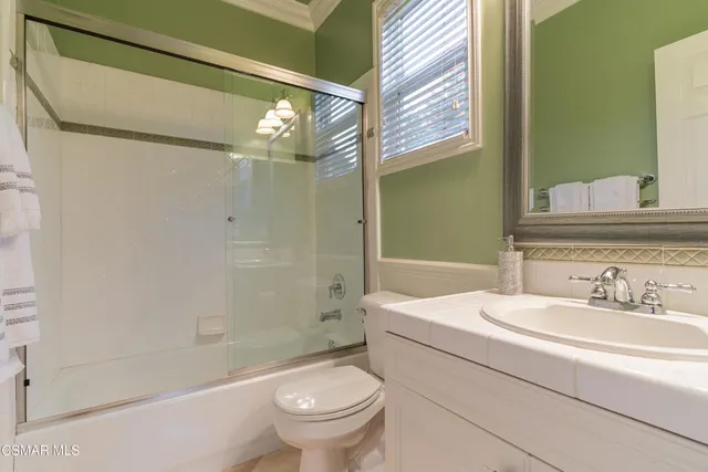 a bed sitting in a bedroom next to a lamp