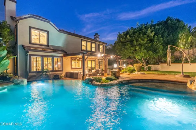 a view of a patio with dining table and chairs
