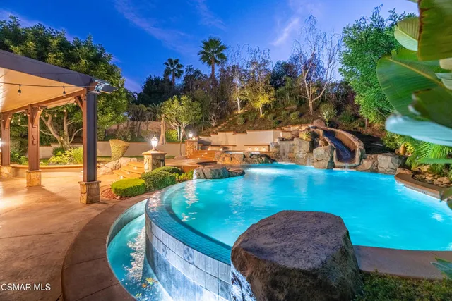a view of a swimming pool with an outdoor seating