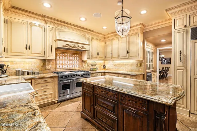 a kitchen with stainless steel appliances granite countertop a stove and cabinets