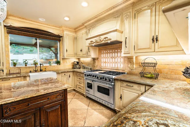 a kitchen with a stove a sink and a wooden cabinets
