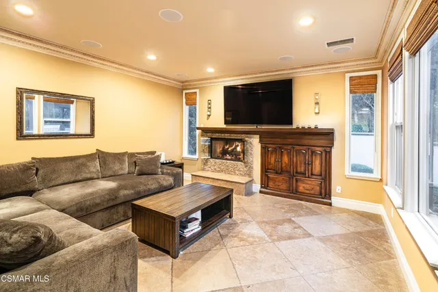 a living room with fireplace furniture and a flat screen tv