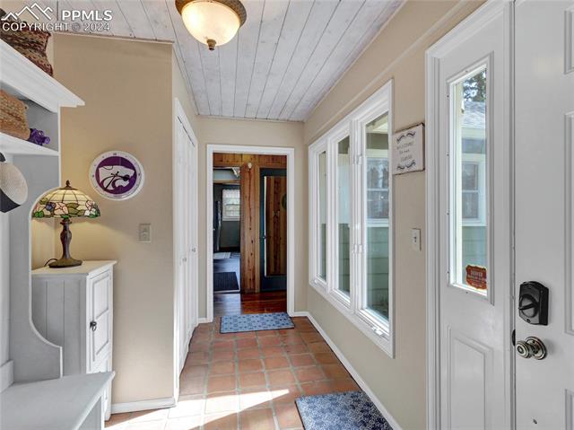 4955 Dodd Road Cascade, CO 80809 - Photo 5 of 45 Corridor with light tile floors and wooden ceiling