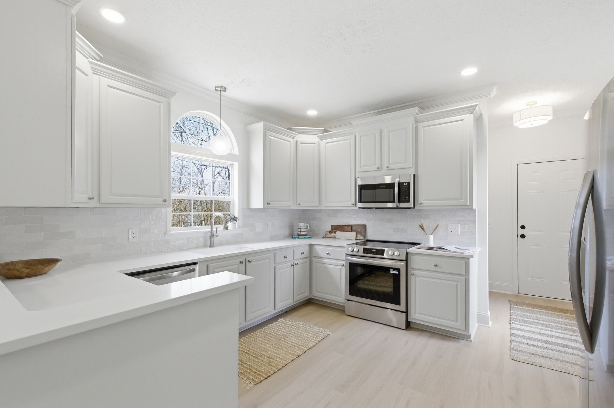 2113 Hanah Court Spring Hill, TN 37174 - Photo 11 of 36 a kitchen with stainless steel appliances granite countertop a sink and stove top oven