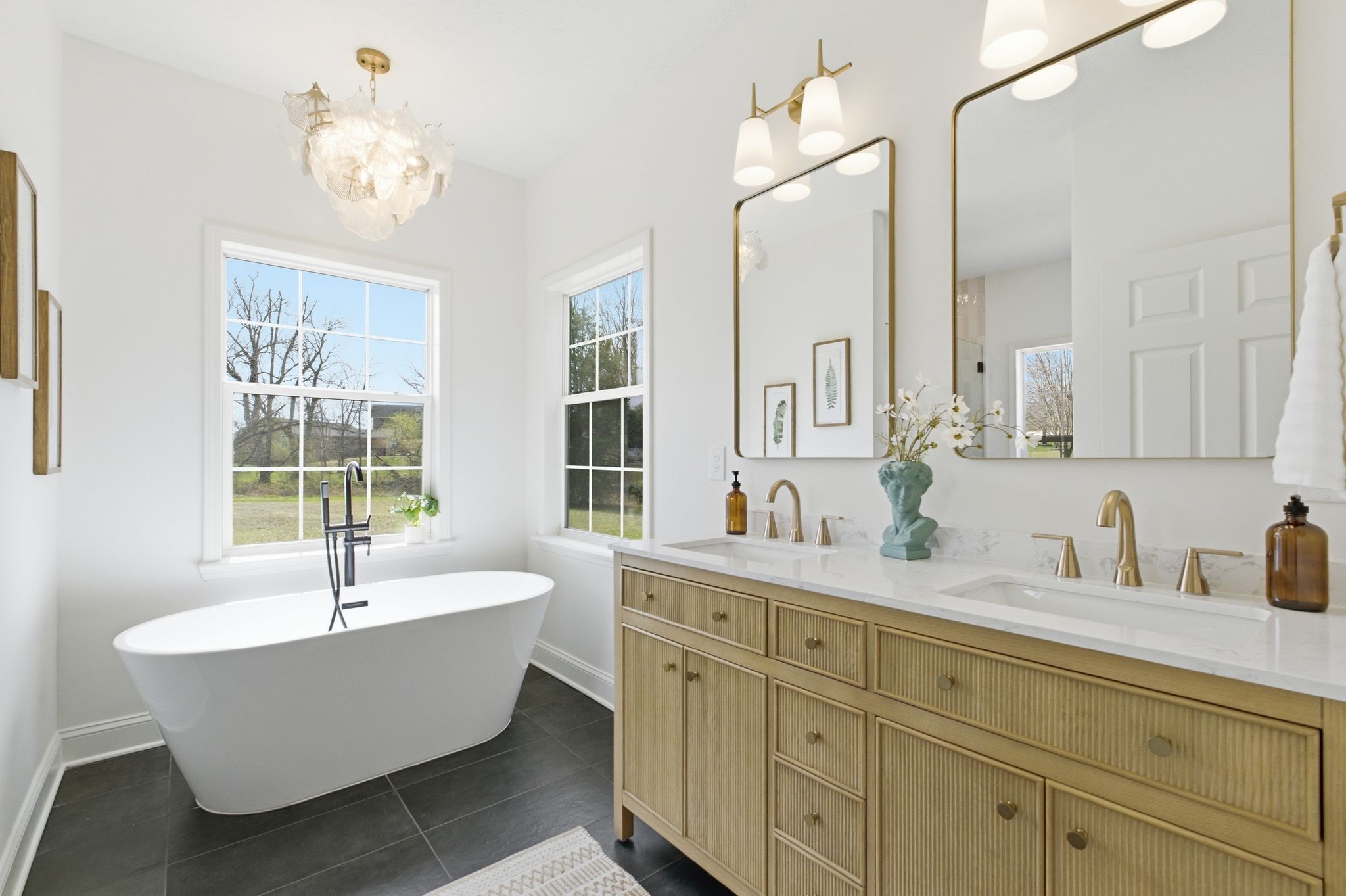 2113 Hanah Court Spring Hill, TN 37174 - Photo 17 of 36 a bathroom with a bathtub a double vanity sink and a window