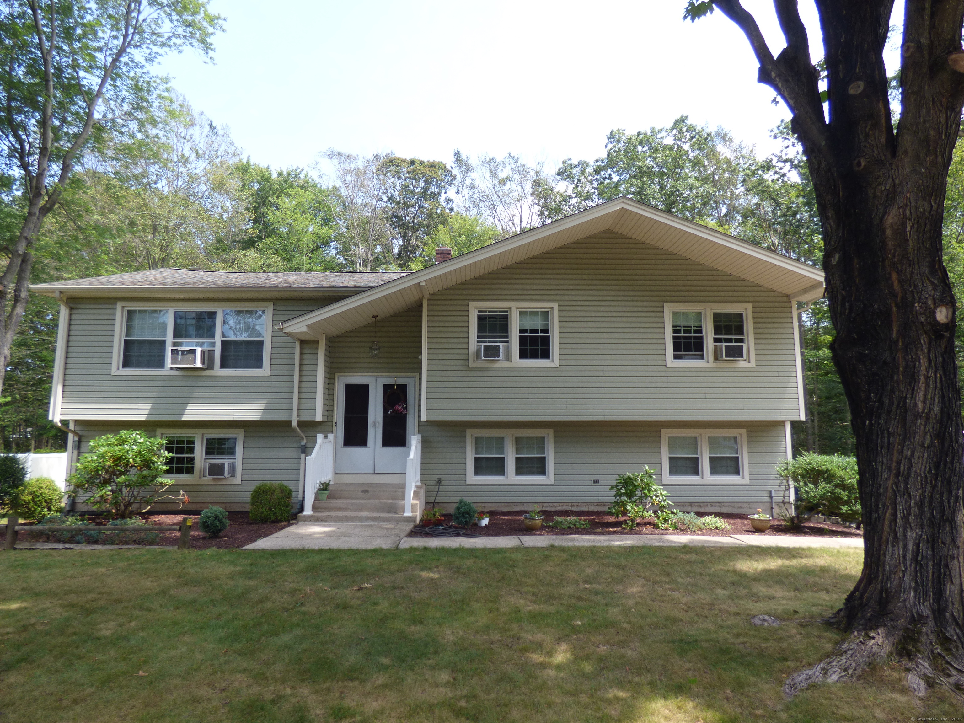 151 McKenzie Drive Southington, CT 06489 - Photo 1 of 1 a front view of a house with a garden