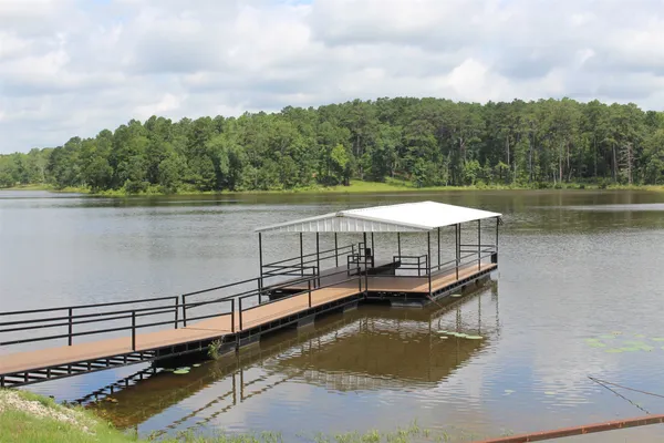 a view of a balcony with wooden floor and outdoor seating
