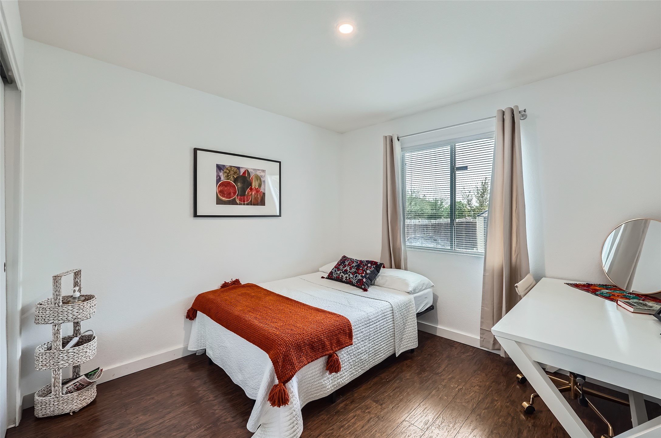 18021 Prairie Verbena Lane Elgin, TX 78621 - Photo 15 of 33 Hardwood floors and a well-lit space create a welcoming ambiance in this comfortable bedroom.