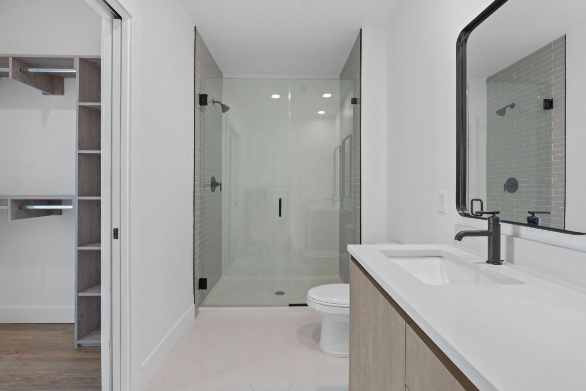 4315 South Congress Avenue, Unit 313 Austin, TX 78745 - Photo 14 of 38 a bathroom with a sink toilet and shower