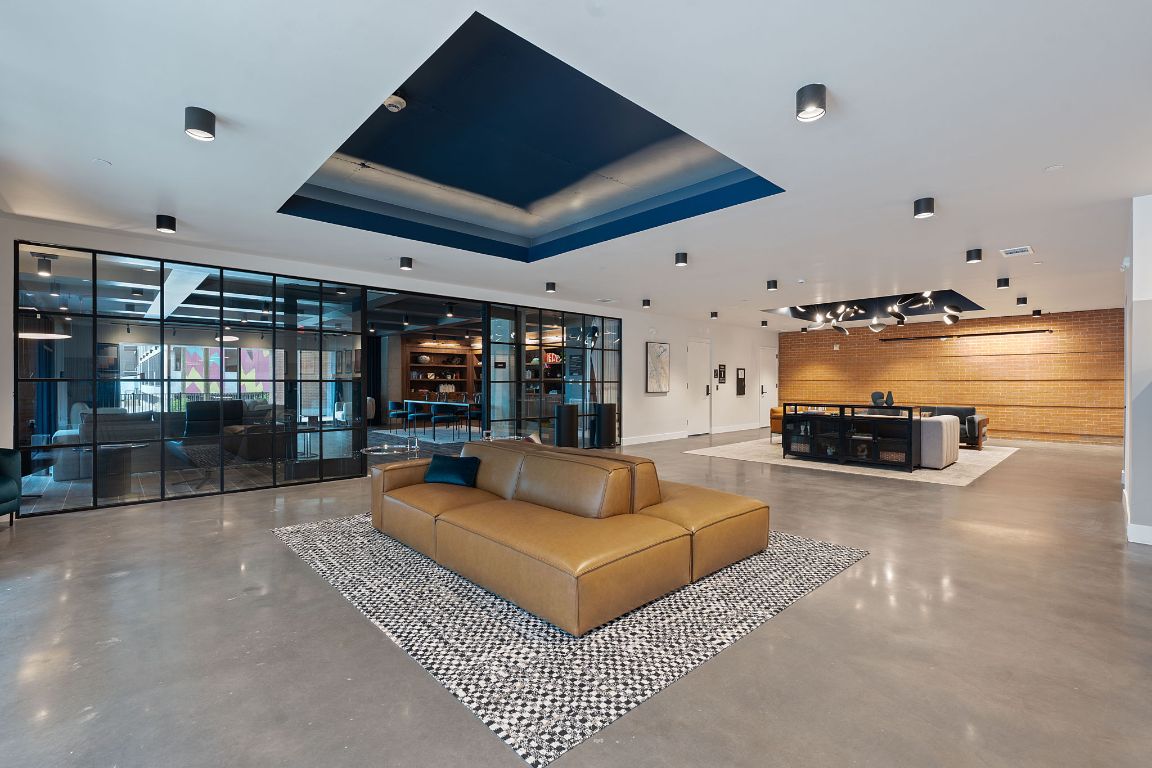 4315 South Congress Avenue, Unit 313 Austin, TX 78745 - Photo 24 of 38 a living room with furniture a lamp and a large window
