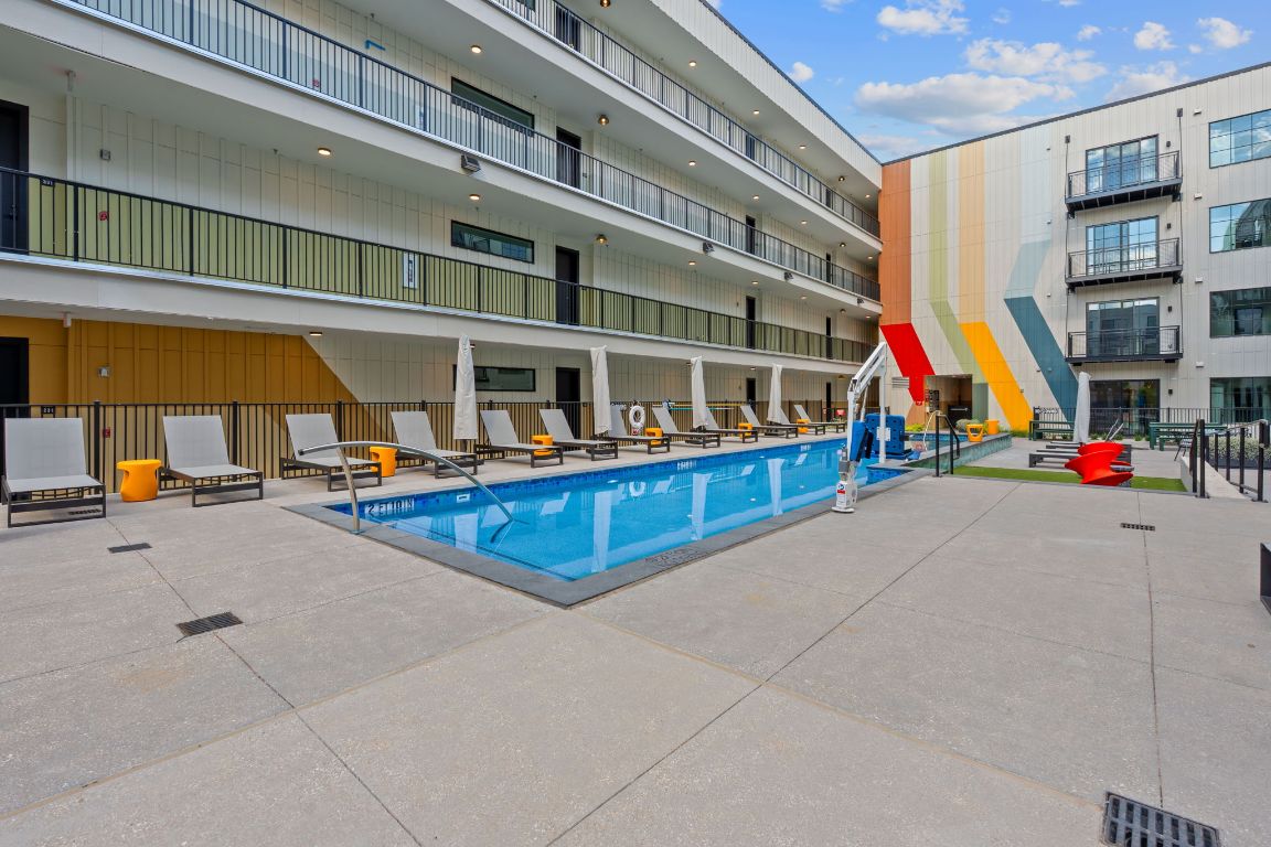 4315 South Congress Avenue, Unit 313 Austin, TX 78745 - Photo 29 of 38 a view of tennis ground with large windows