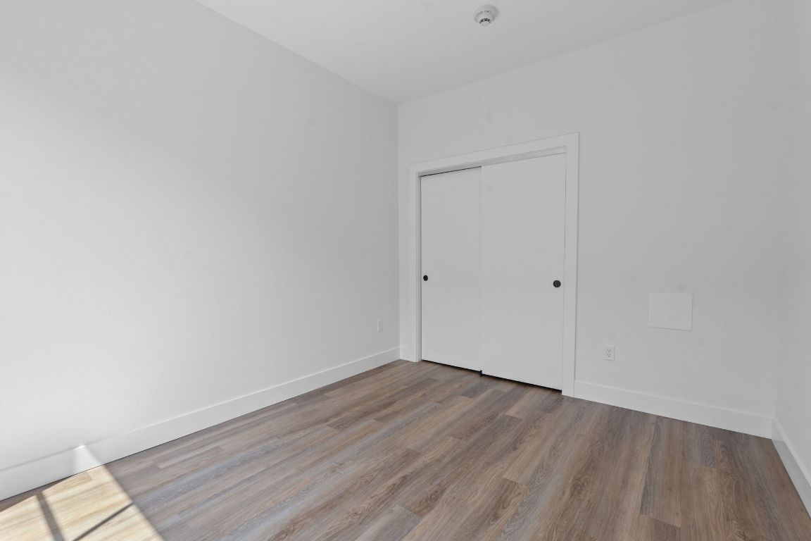 4315 South Congress Avenue, Unit 313 Austin, TX 78745 - Photo 5 of 38 a view of an empty room with wooden floor