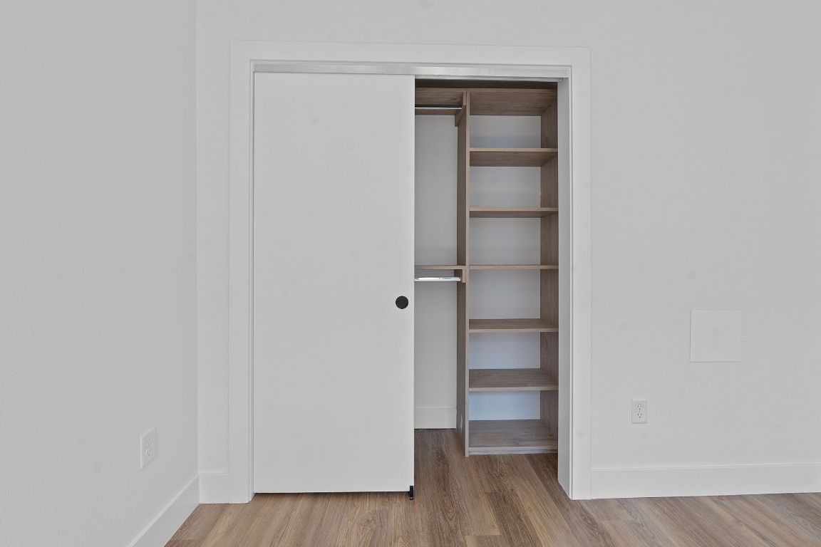 4315 South Congress Avenue, Unit 313 Austin, TX 78745 - Photo 7 of 38 a view of an empty walk in closet with wooden floor