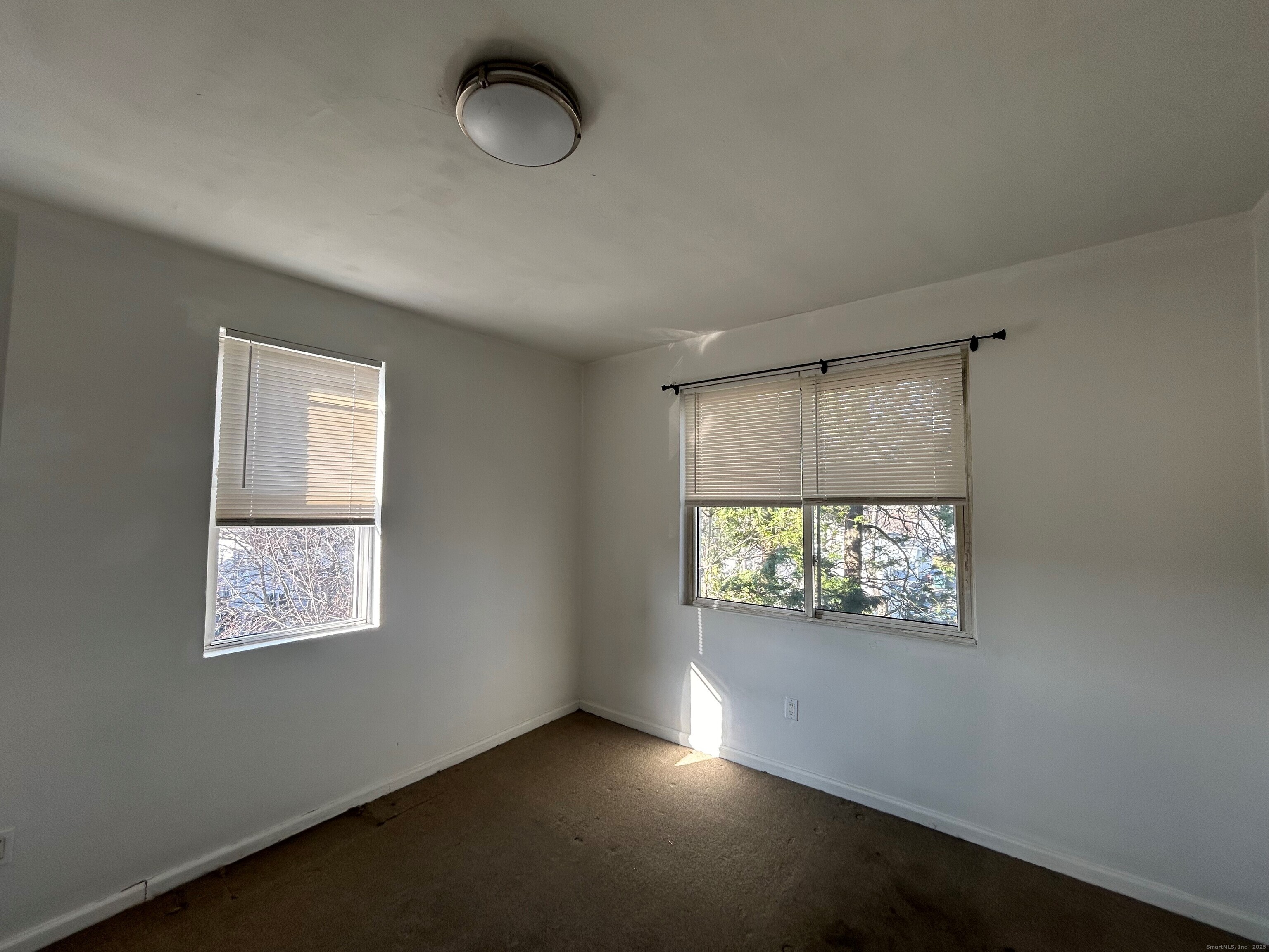 4 5th Avenue, Unit 8 Danbury, CT 06810 - Photo 2 of 3 an empty room with windows and chandelier