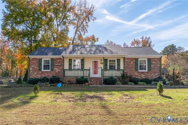 a view of a house with swimming pool and a yard