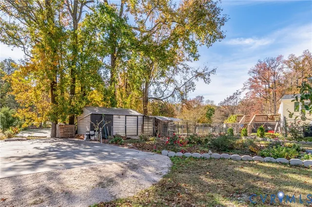 a front view of a house with a yard and large trees