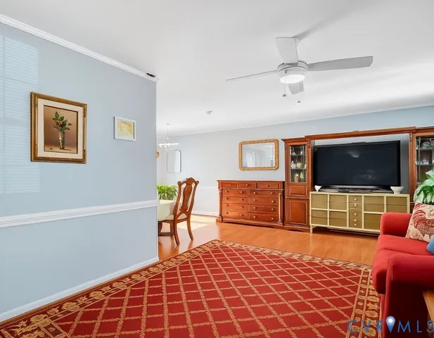 a bedroom with furniture and a flat screen tv