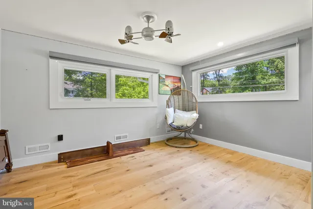 a view of a room with a window and ceiling fan