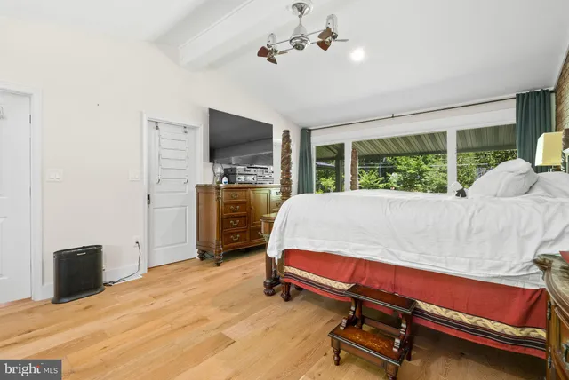 a bedroom with a bed and a television