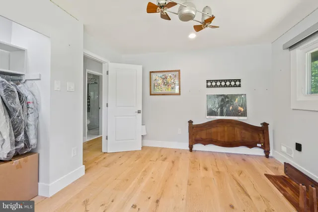 a bedroom with a bed dresser and a window