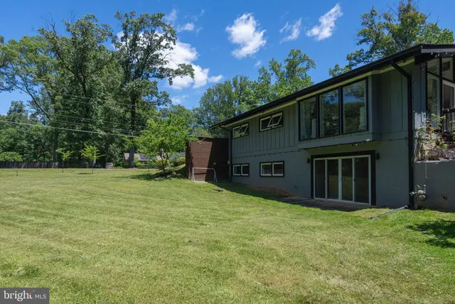 a view of backyard of house with green space