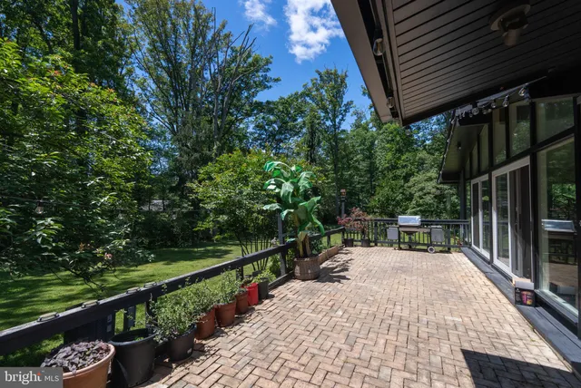 a view of a house with a yard and potted plants