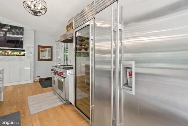 a kitchen with stainless steel appliances granite countertop a refrigerator and a sink