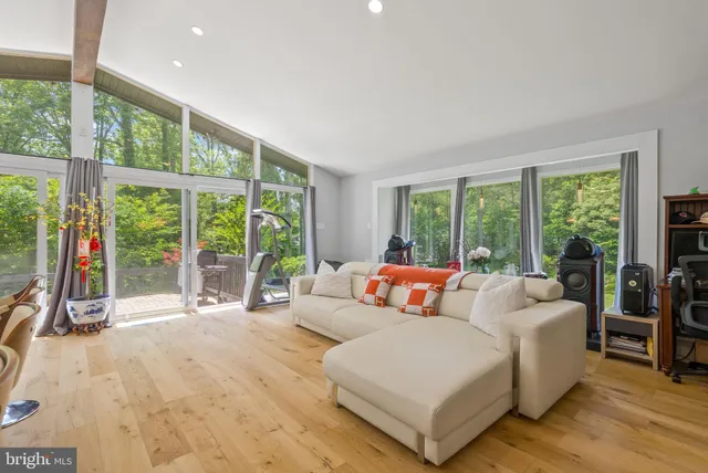 a large bedroom with a bed and glass windows