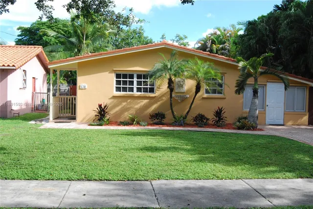 a view of a backyard with table and chairs under an umbrella