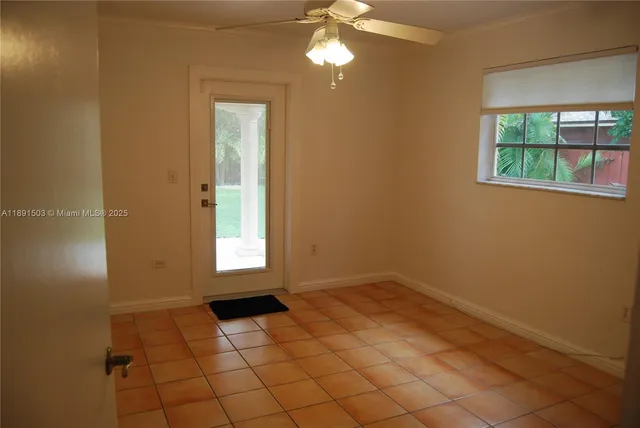 an empty room with windows and entrance