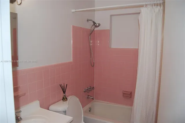 a bathroom with a shower and a toilet