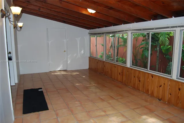 a view of an empty room with windows