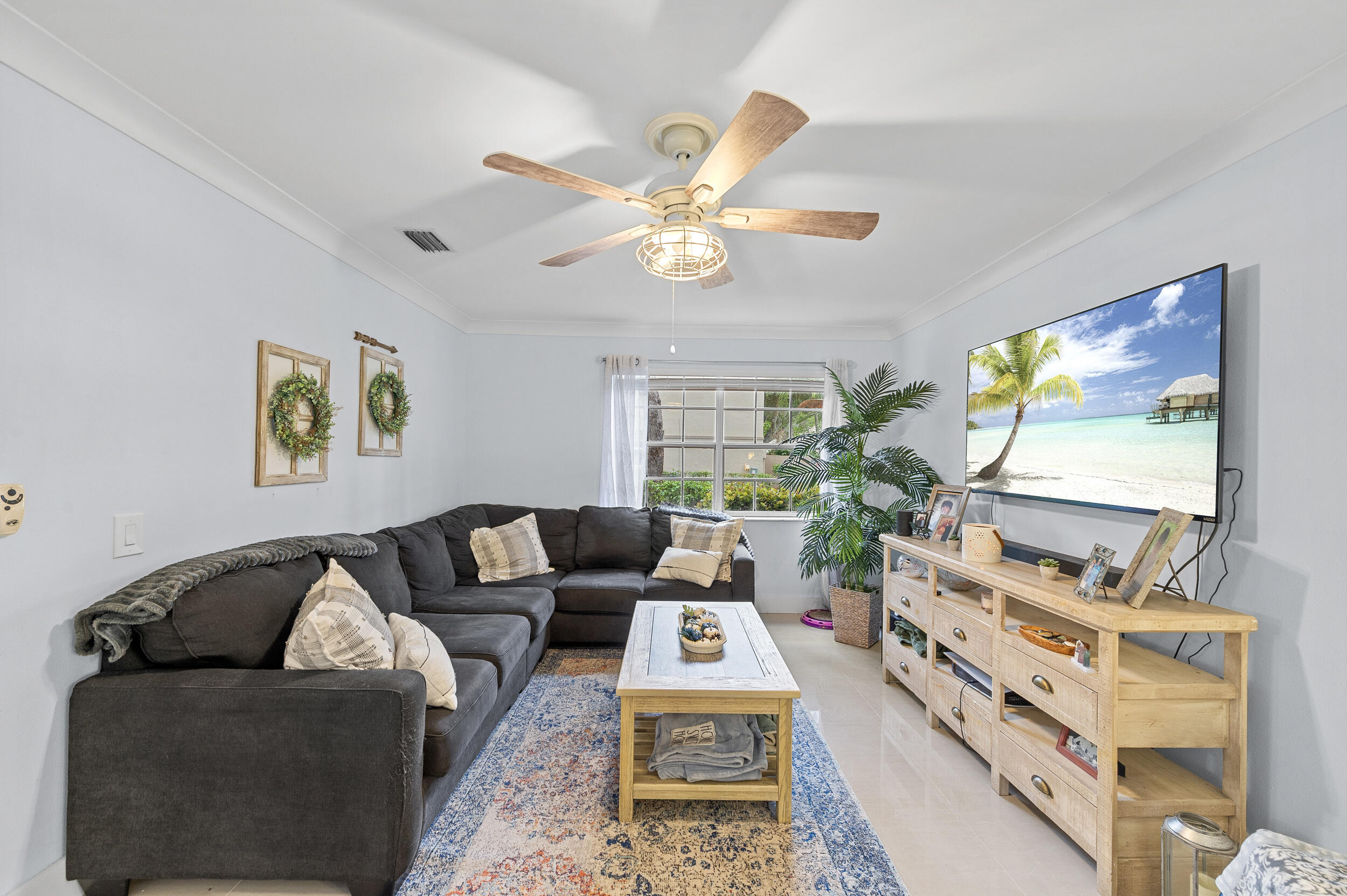 6548 Via Regina Boca Raton, FL 33433 - Photo 19 of 41 a living room with furniture and a flat screen tv