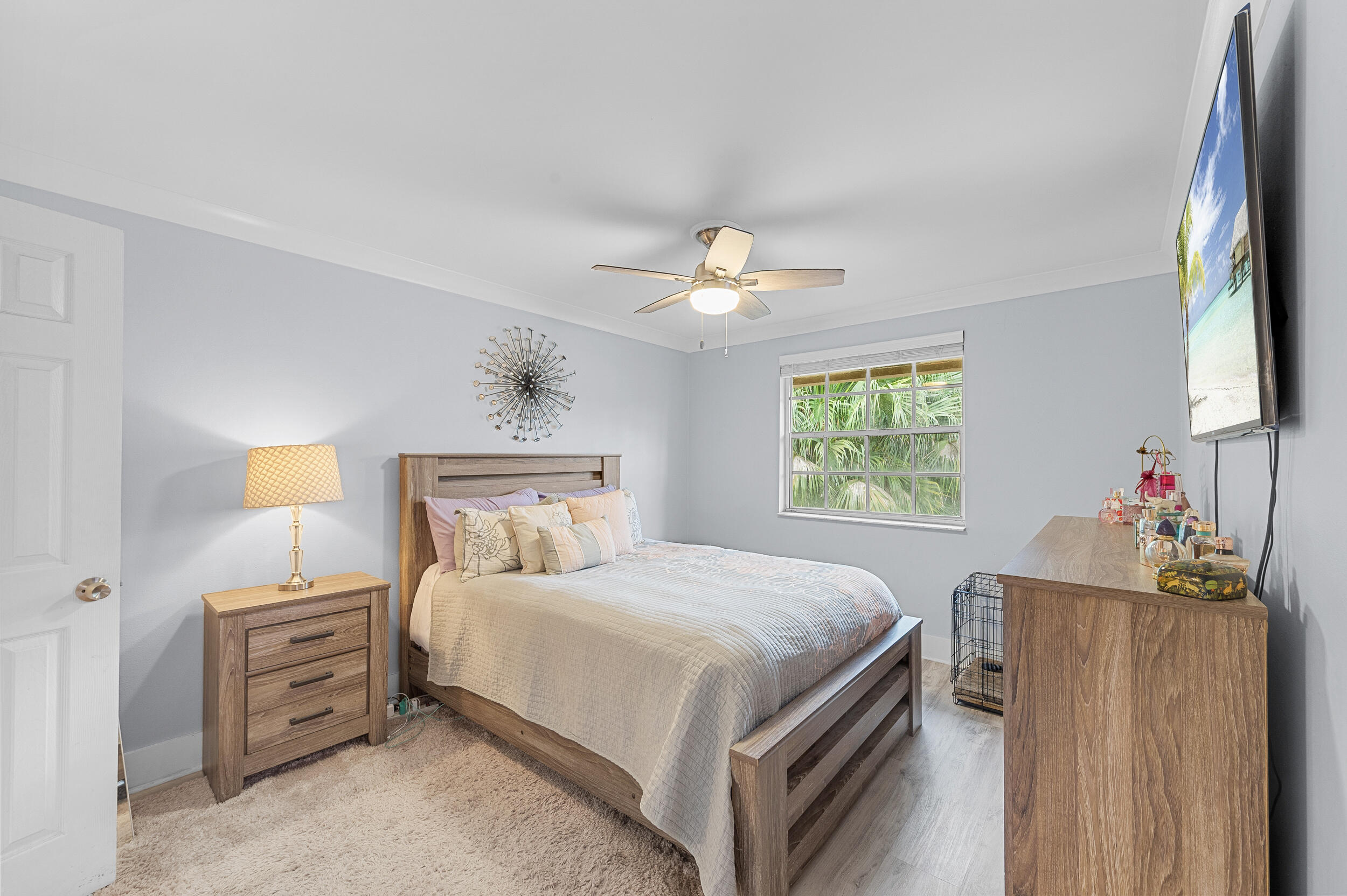 6548 Via Regina Boca Raton, FL 33433 - Photo 26 of 41 a bedroom with a bed and a chandelier