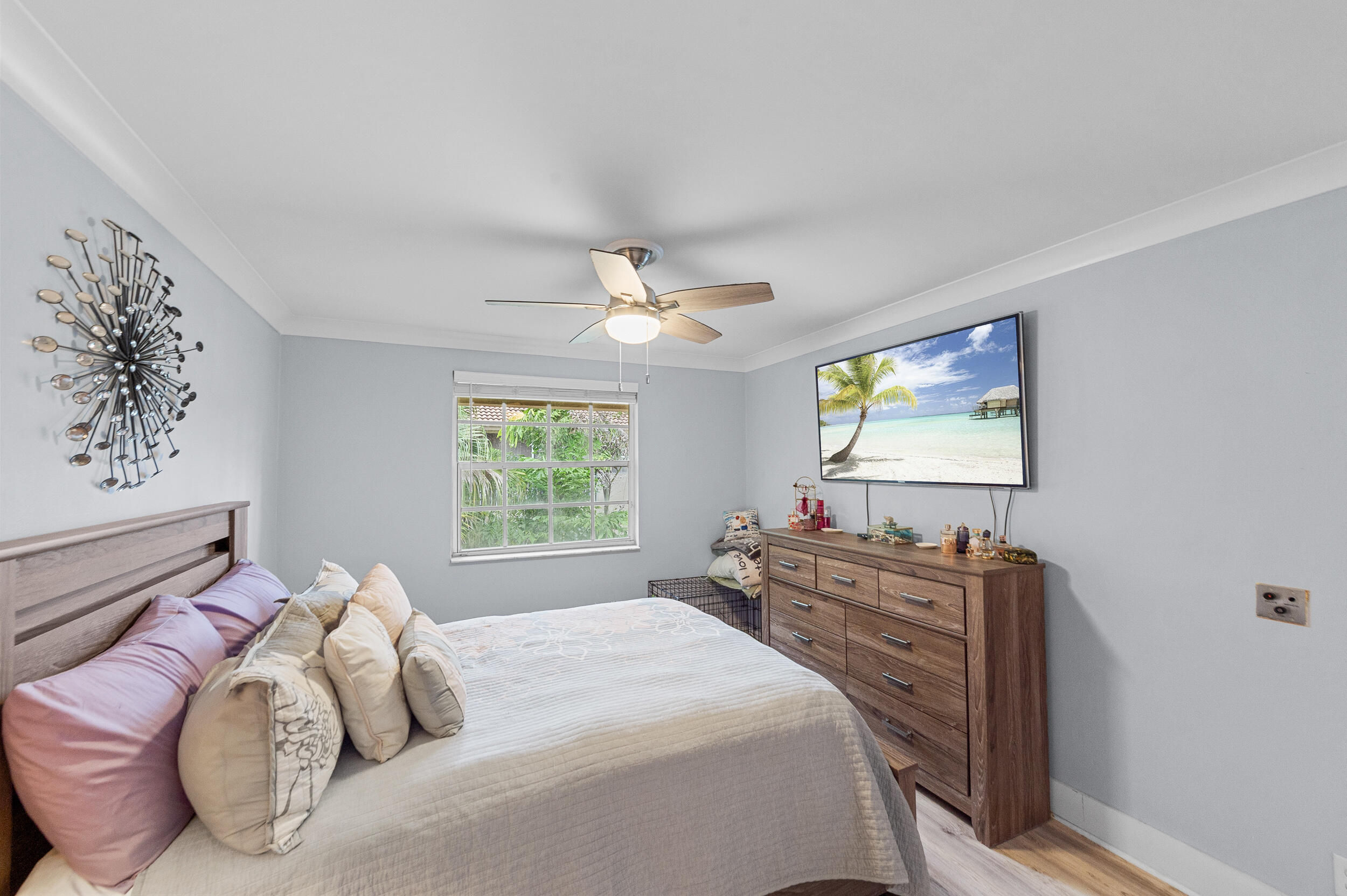 6548 Via Regina Boca Raton, FL 33433 - Photo 27 of 41 a bedroom with a bed and a flat tv screen on dresser