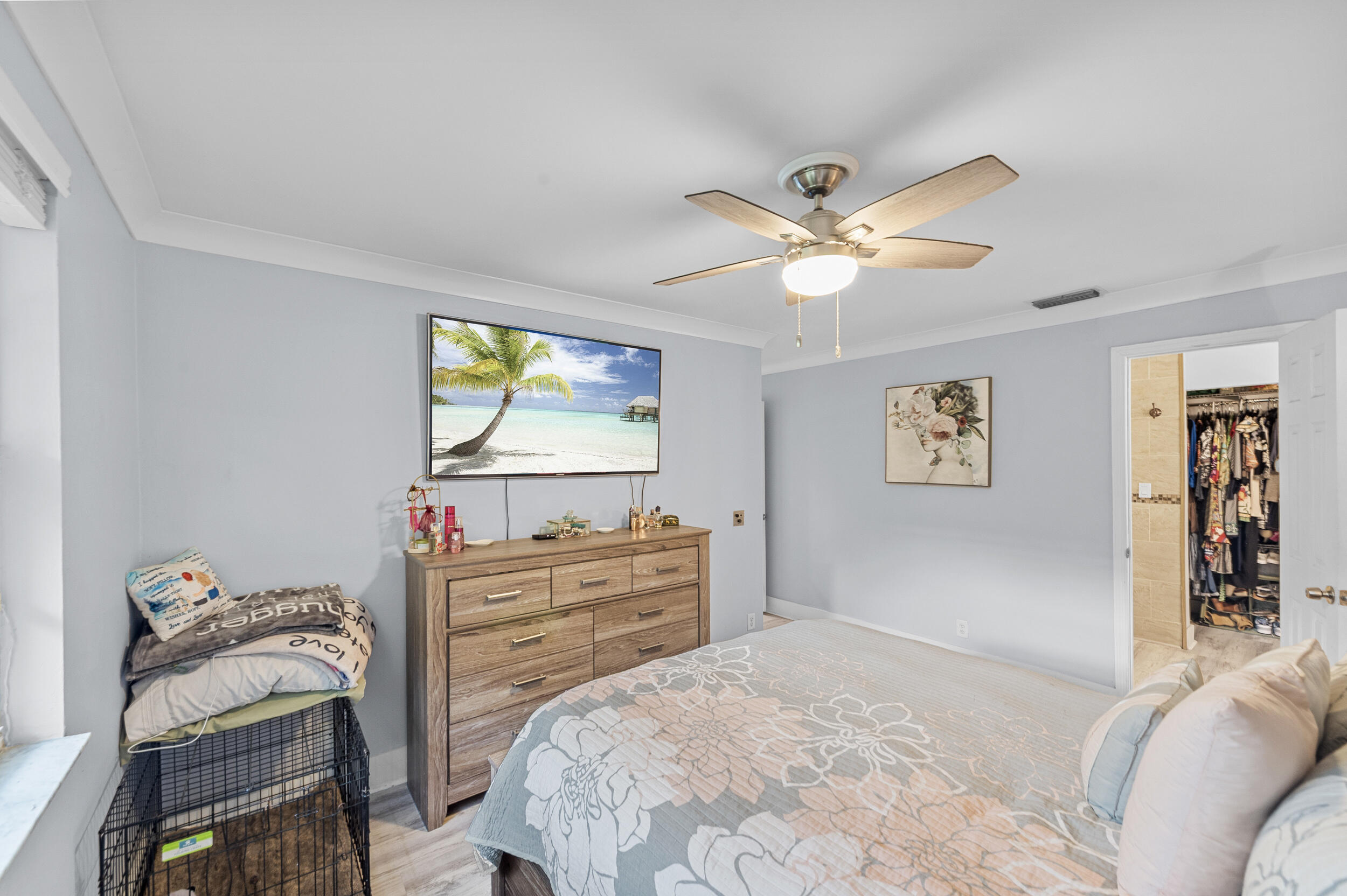 6548 Via Regina Boca Raton, FL 33433 - Photo 28 of 41 a bedroom with a bed and a chandelier